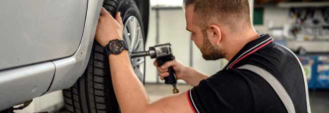 Expert MINI technician installing new tires